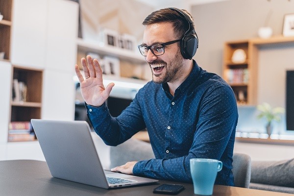 Employee playing virtual escape room game, taking part in virtual team building game with remote colleagues